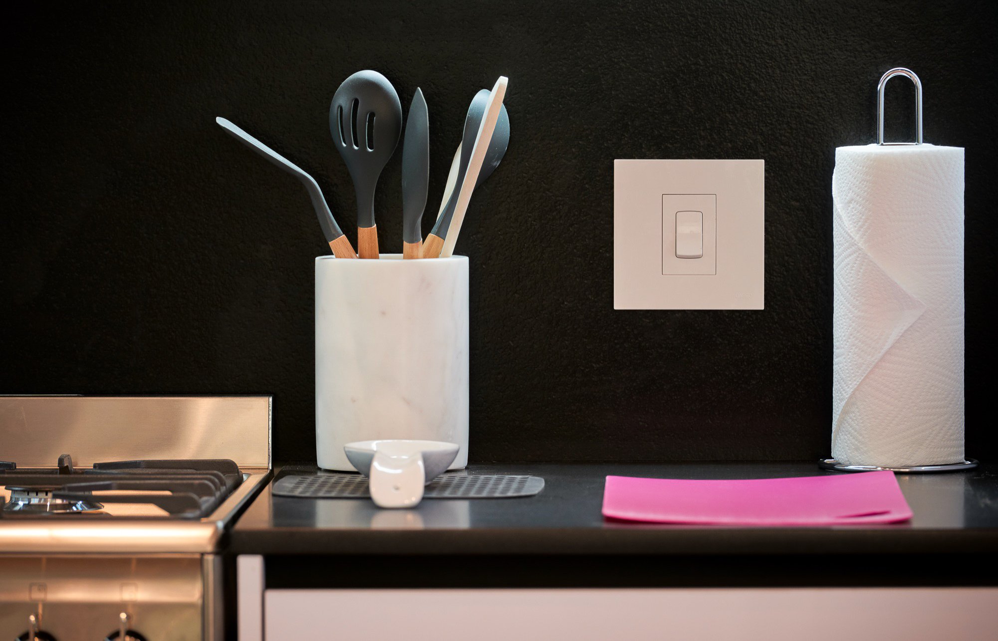 Kitchen utensils against the dark counter