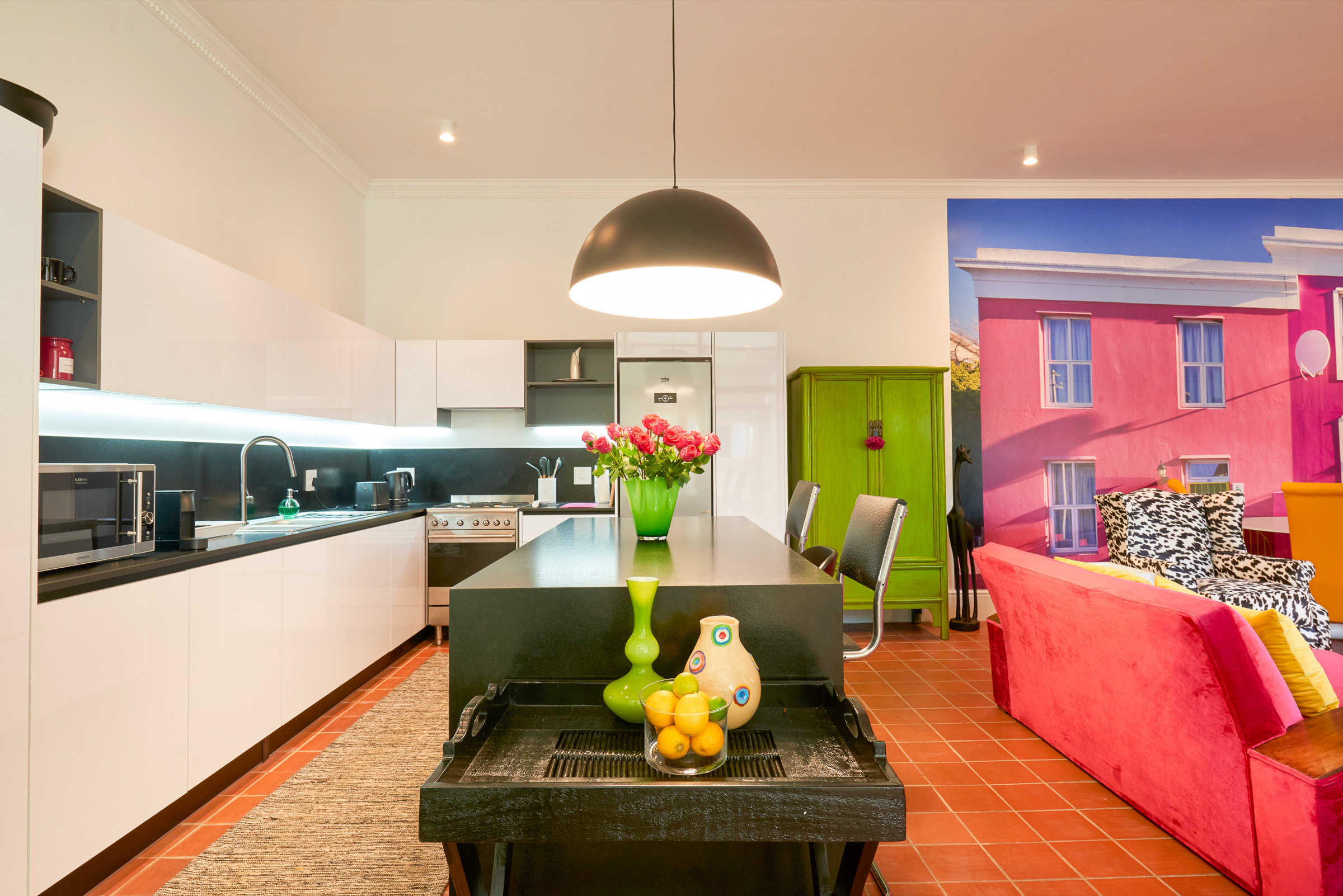 Kaleidoscope kitchen, with the granite island and the Bo-Kaap mural beyond