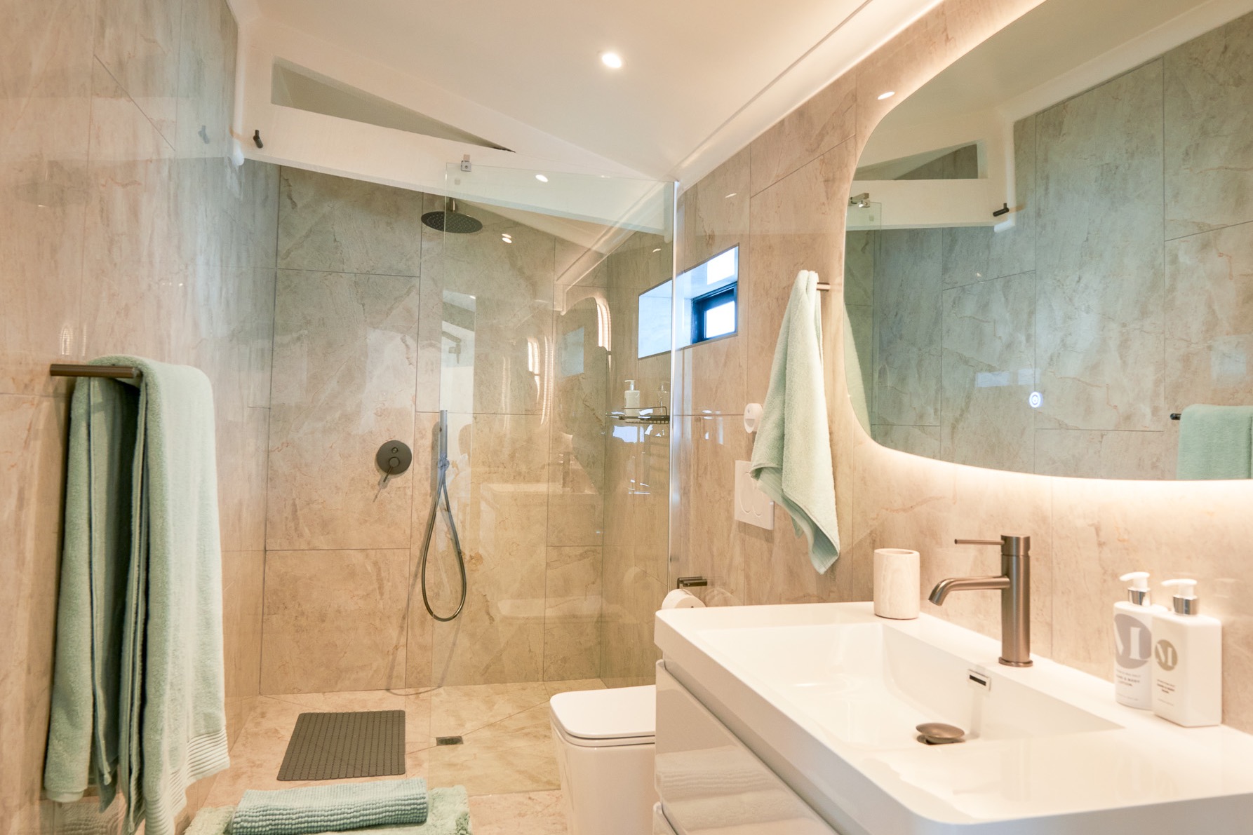 The Sage bathroom, with the walk-in shower and the backlit mirror