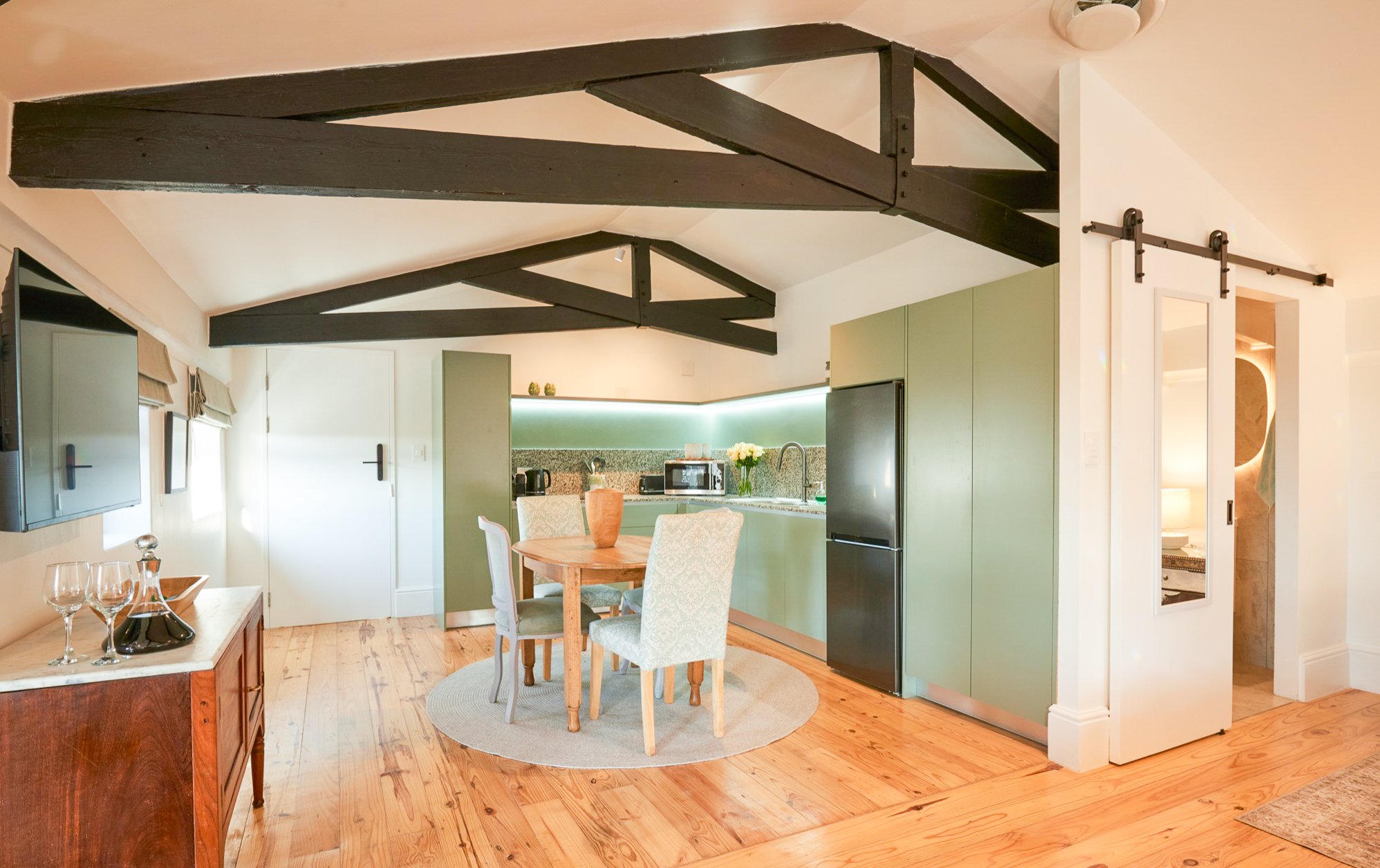 The Sage dining and kitchen under the roof trusses